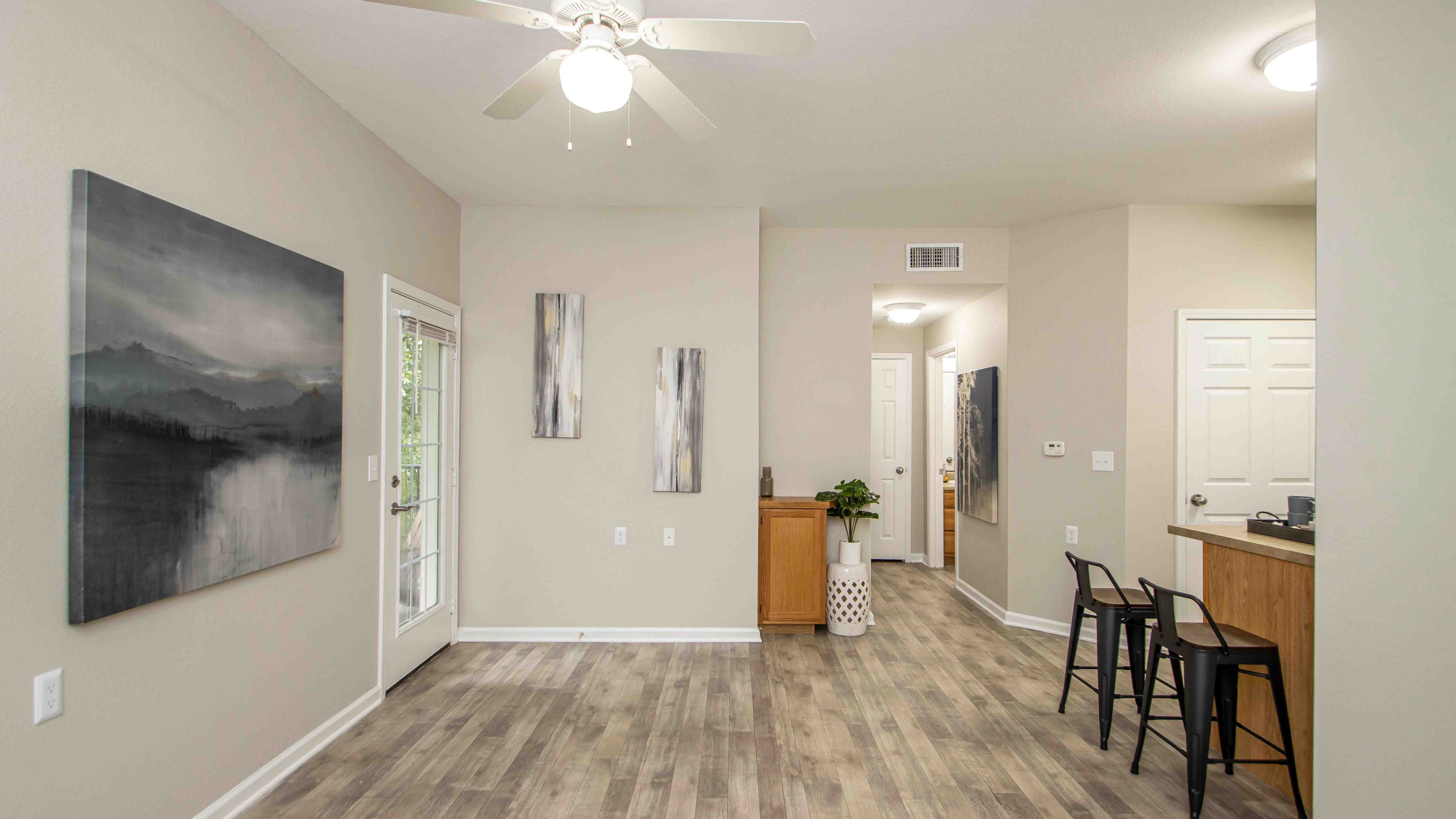 Step into our inviting living spaces with the allure of a French door beckoning you to an intimate outdoor patio. 