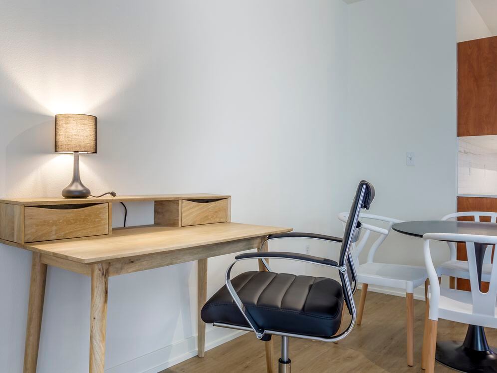 Furnished+ apartment homes include an office desk and chair (Representative Image – exact items and style of furnishings may vary)