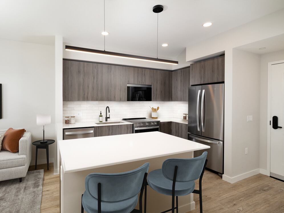 Upgrade Collection II One-bedroom kitchen and dining area with hard-surface vinyl plank flooring 