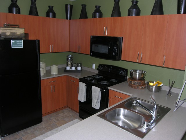 The Pravada finish package features warm cherry cabinets and black appliances