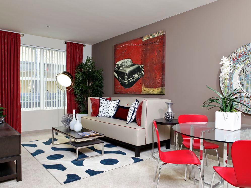 Living room with carpet (select homes)