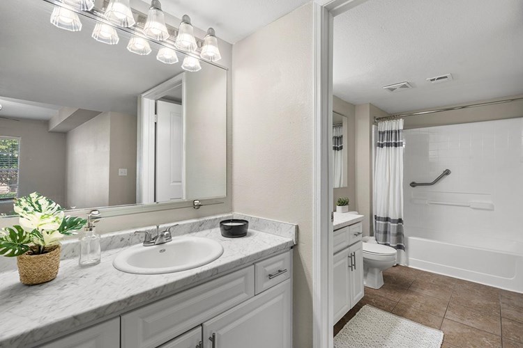 Our newly remodeled bathrooms feature wood-style or tile flooring, marble-style countertops, and large mirrors.