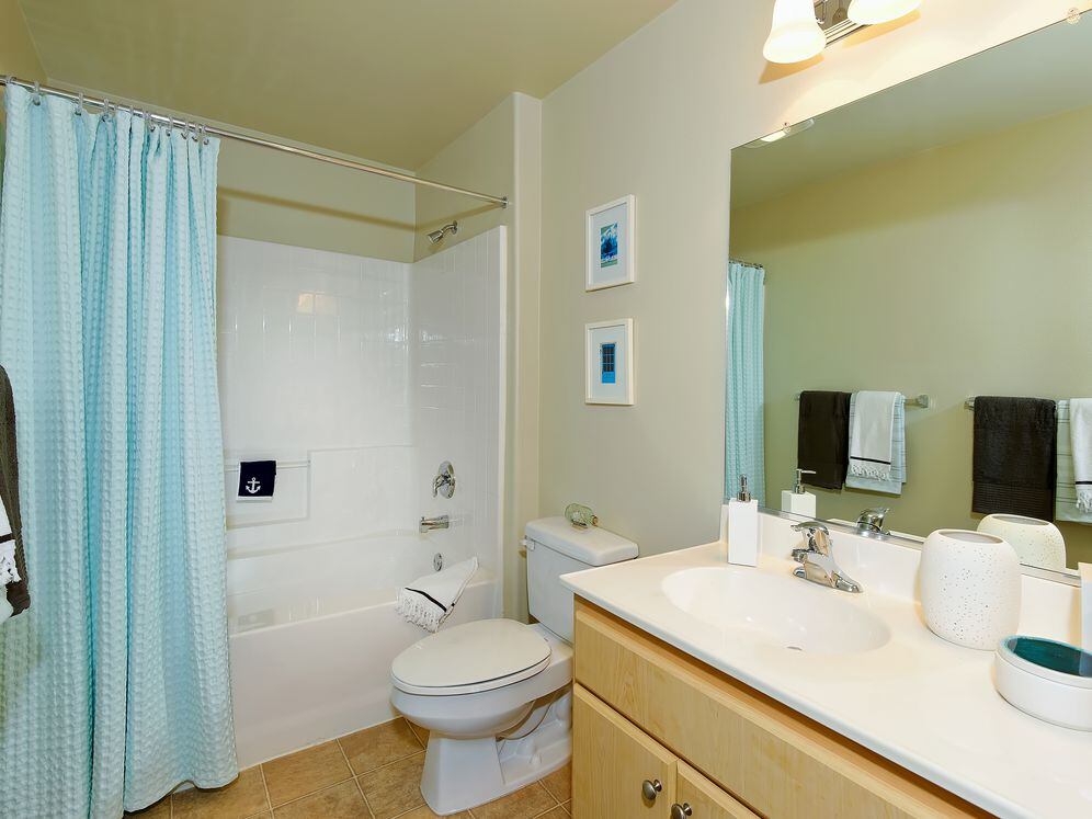 Classic Package I bath with white laminate countertops, light cabinetry, and tile flooring
