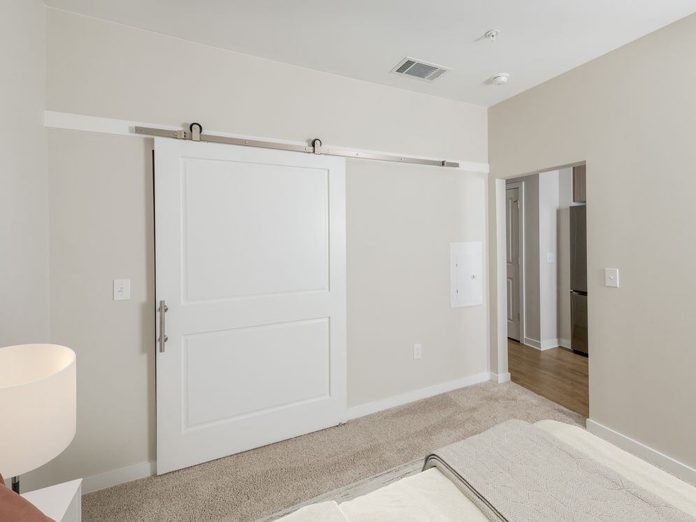 Studio bedroom with sliding barn door closet