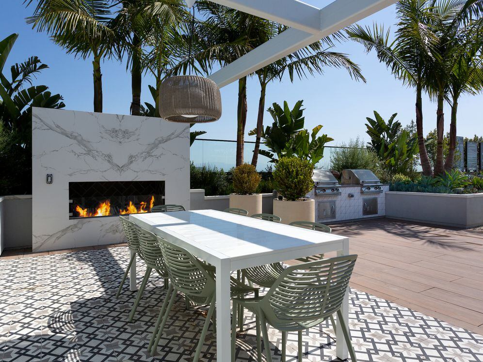 Building A rooftop lounge with fireplace, grills and seating