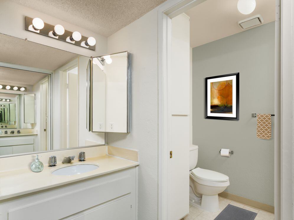 Classic Package bath with white laminate countertops and white cabinetry