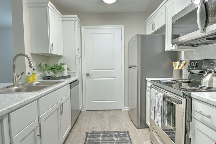 Discover designer kitchen elegance with ample storage in our updated kitchens.