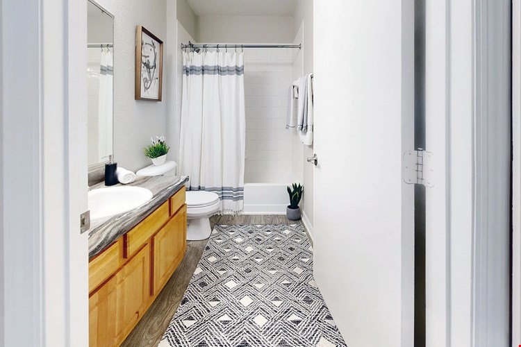 Serenity resides in the details of our signature bathroom at Eagle's Pointe. Immerse yourself in comfort and style with updated, refined finishes including wood-style flooring and black fusion countertops.