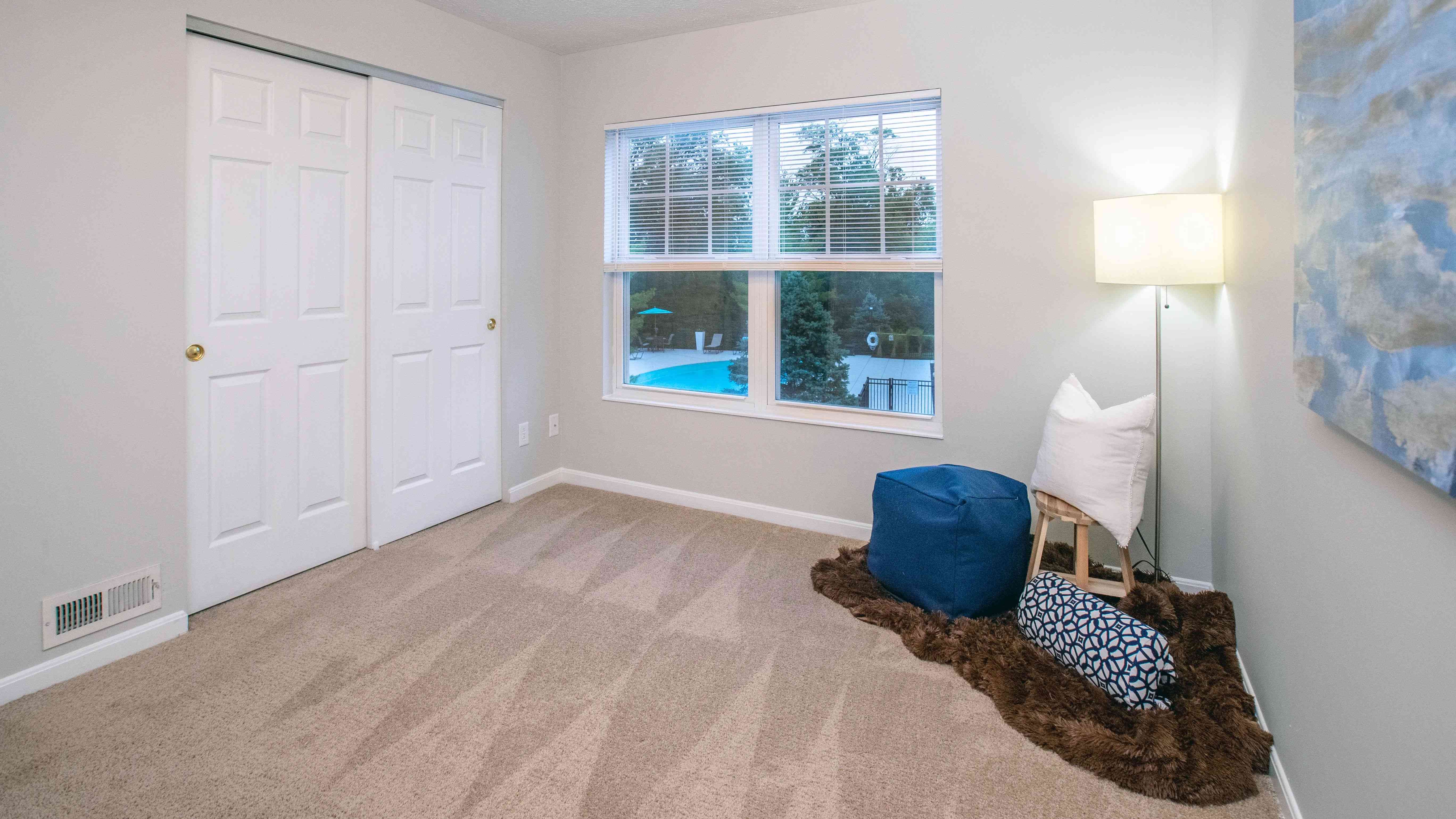 Spacious bedrooms featuring plush carpeting, large closets, and expansive windows.