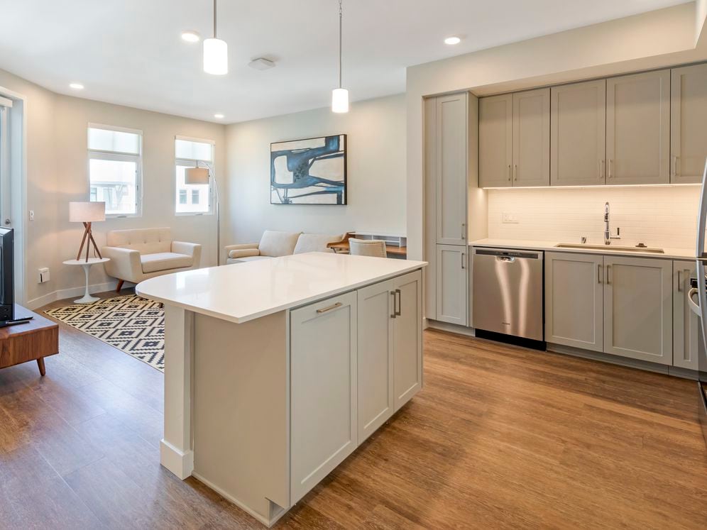 Furnished+ apartment homes come outfitted with a sofa, side chair, side table, coffee table, TV stand and 50" Television (Representative Image – exact items and style of furnishings may vary)