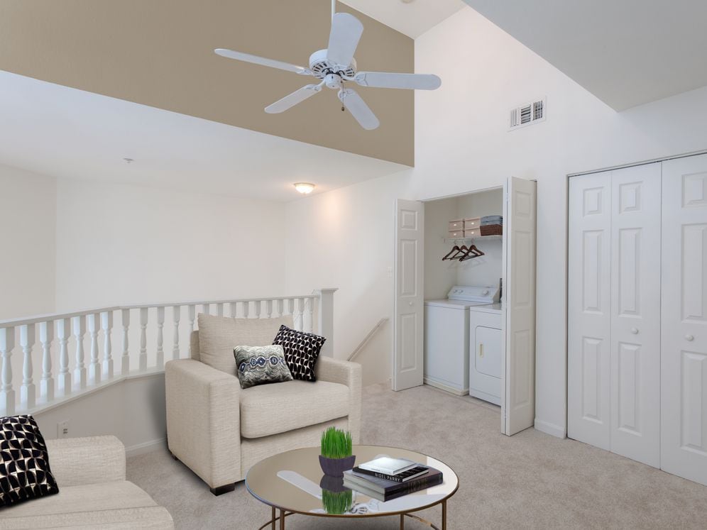 Loft with in-unit washer and dryer and carpeted flooring