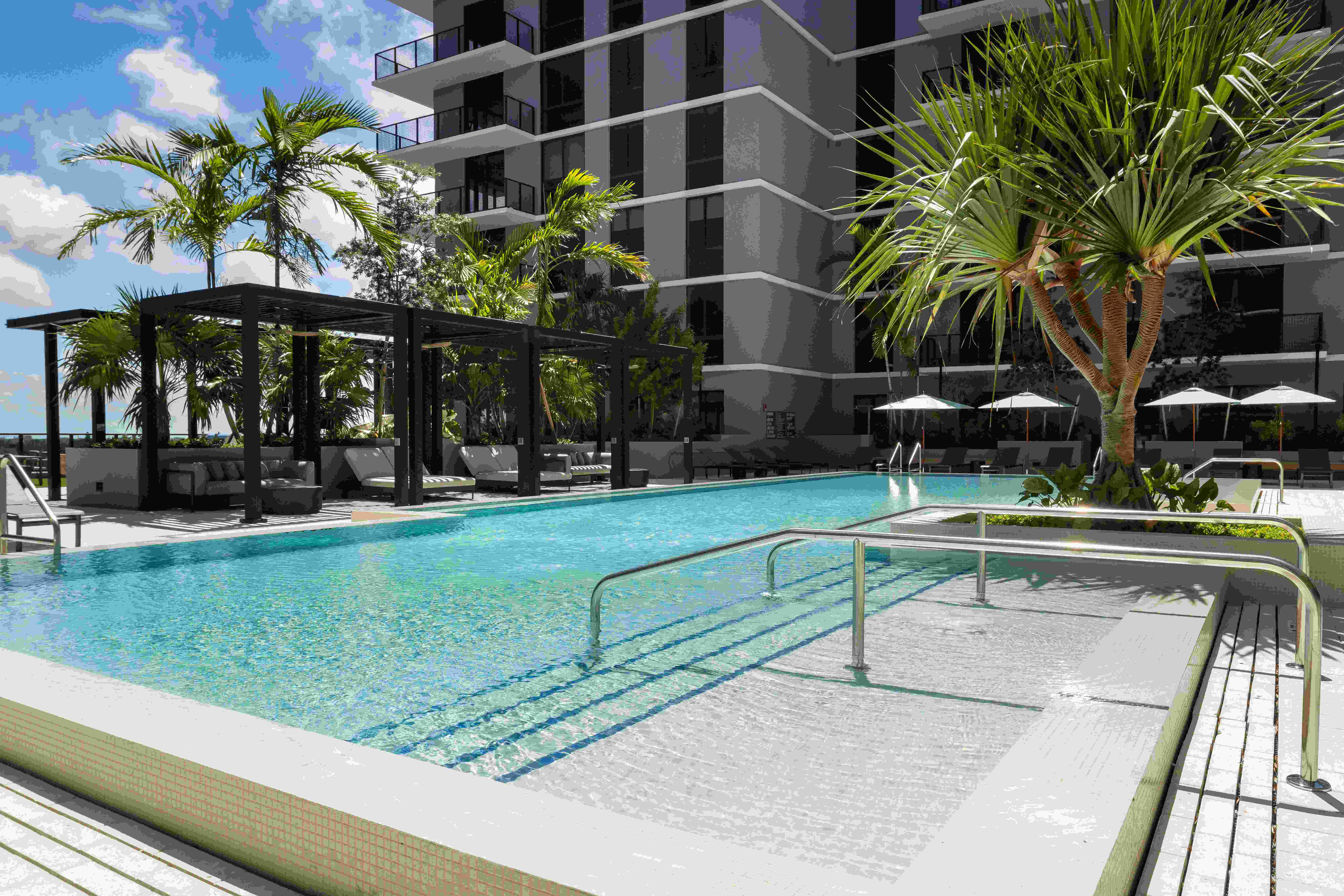 Resort-style pool and sundeck with cabanas
