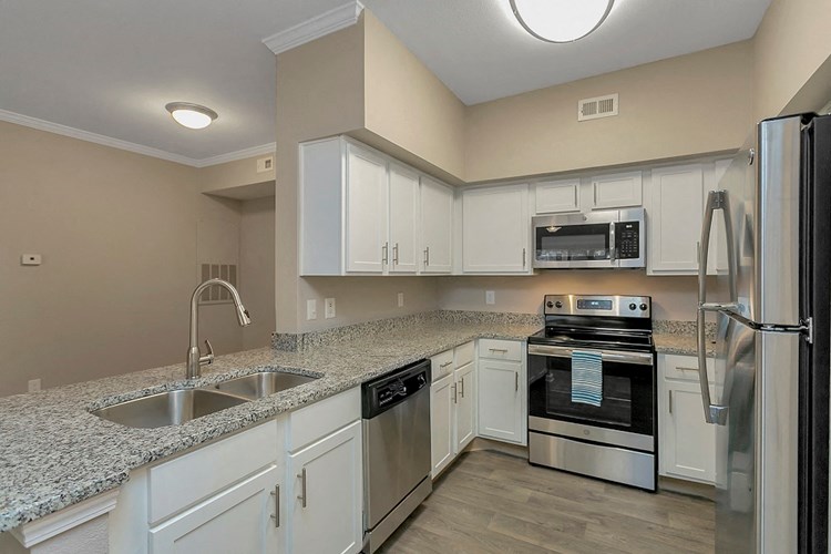 Fully Equipped Kitchen with Fridge, Microwave, and Stove Featuring Granite Countertops