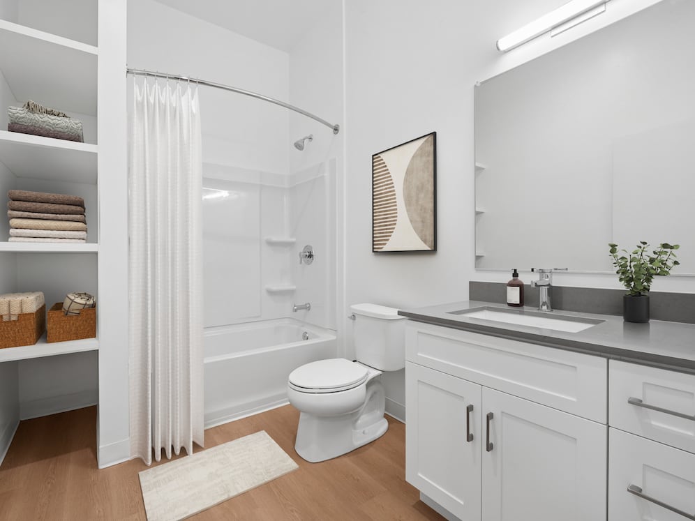 Upgrade Collection bath with white cabinetry, grey quartz countertop, and hard surface flooring