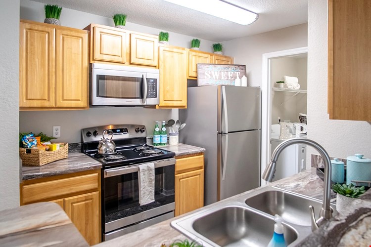 Discover the heart of home with signature kitchen elegance of modern upgrades - featuring wood-style flooring, granite-style countertops, and stainless steel appliances - creates a space that's as inviting as it is practical.