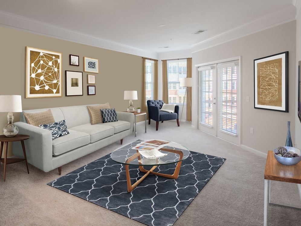 Living and dining area with accent wall and carpet