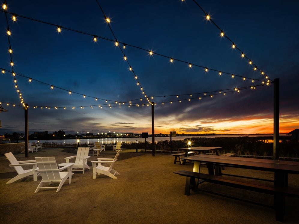 Landscaped courtyard with lounge seating and waterfront views