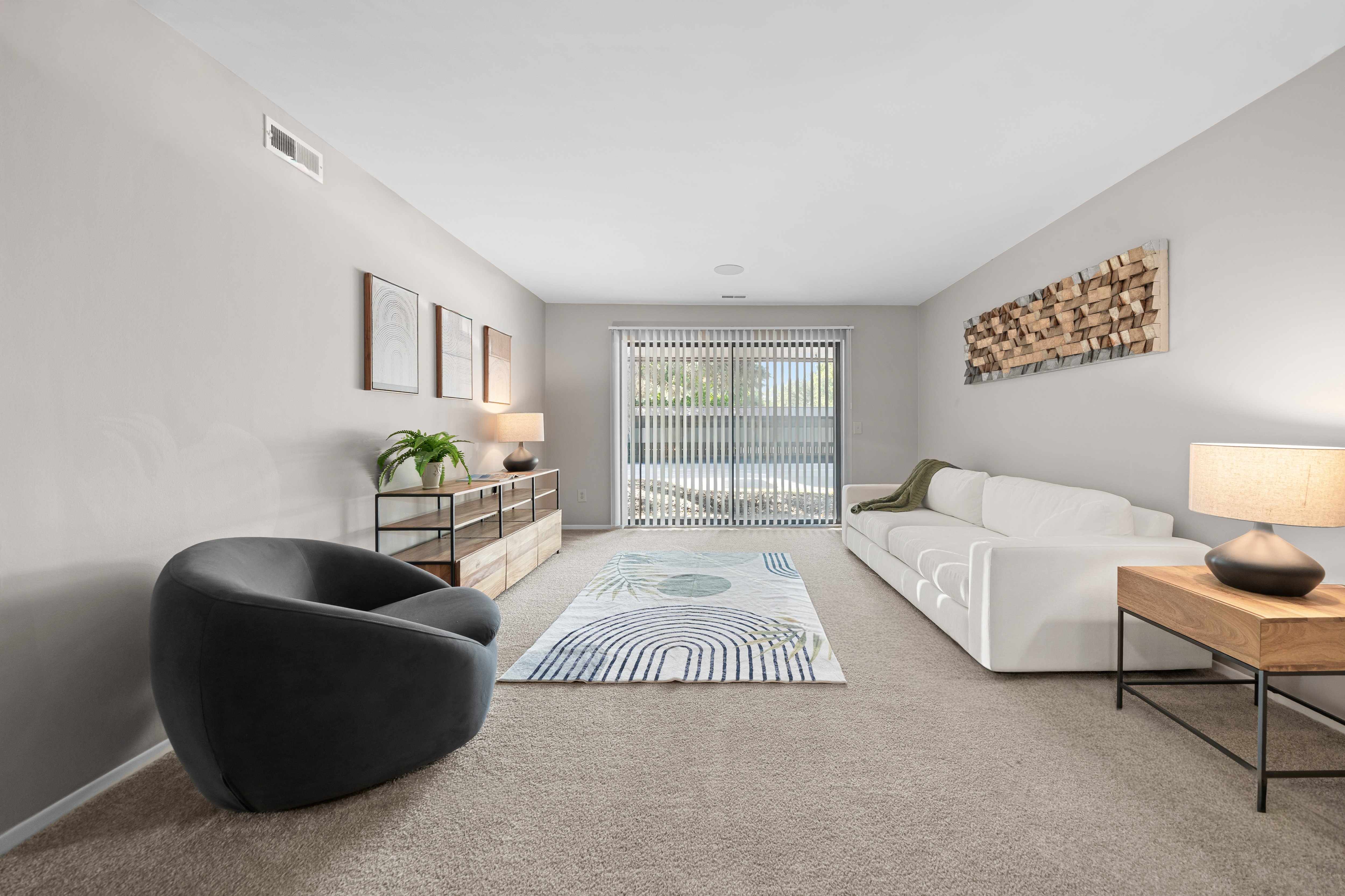 Spacious Living Room with Sliding Glass Door at Lakeside Village Apartments Clinton Township MI