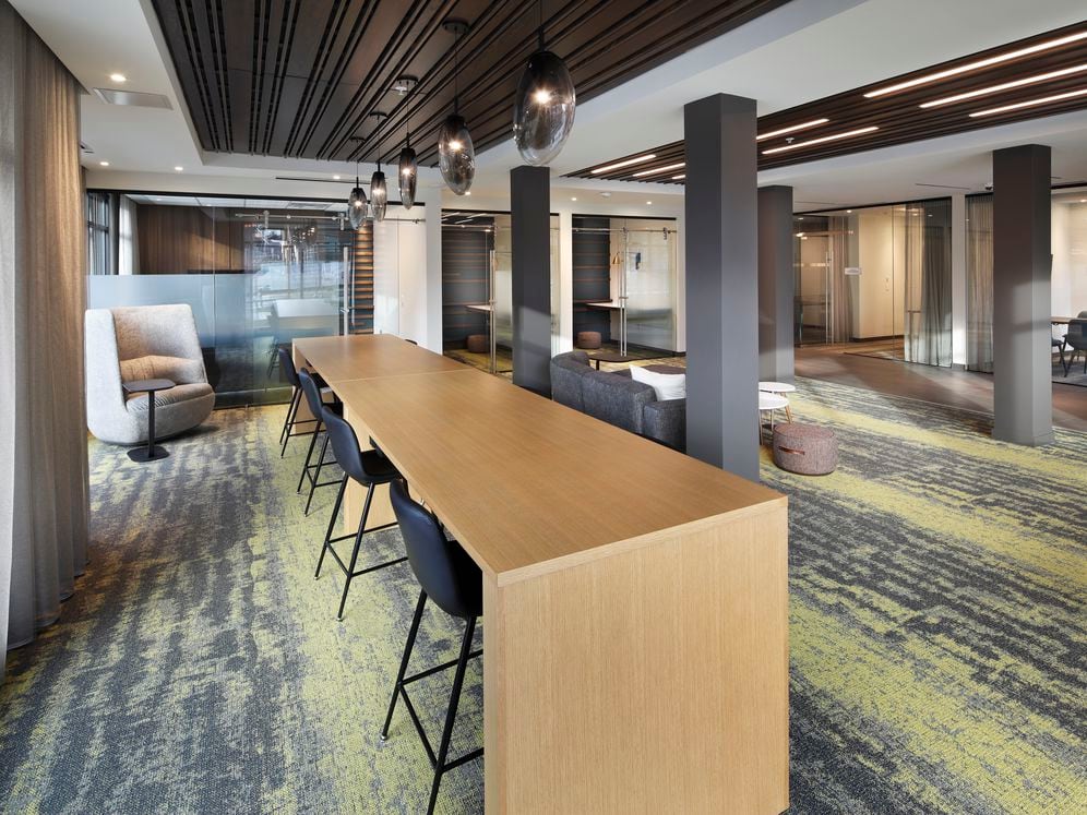 Phase II Hive Co-Work Lounge with separate seating areas and private office spaces, perfect for working remote