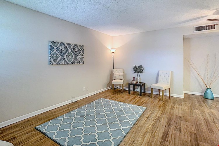 Spacious open living rooms with wood-style flooring.