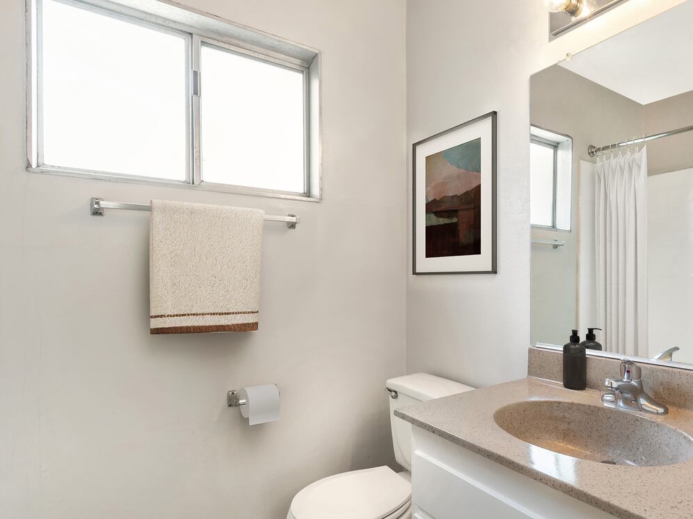 Classic Package I bath with beige laminate countertops, white cabinetry, and hard surface flooring