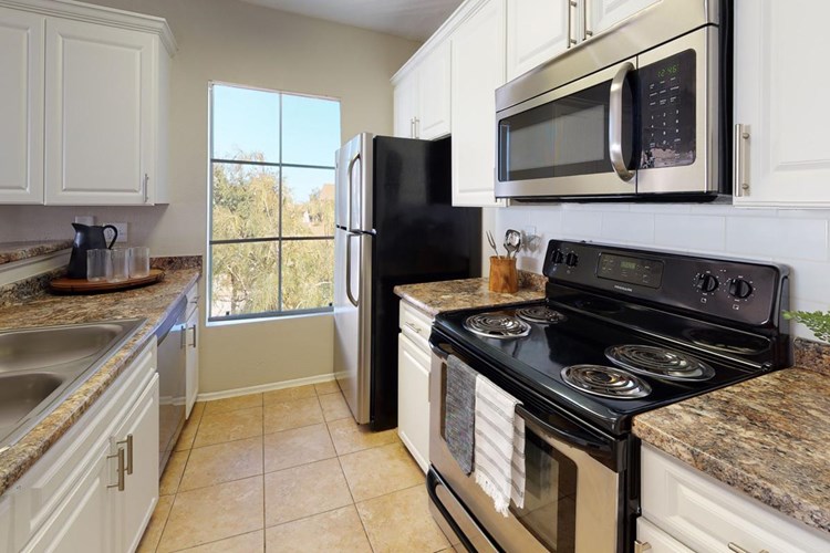 Kitchens feature all stainless steel appliances, including a dishwasher. 