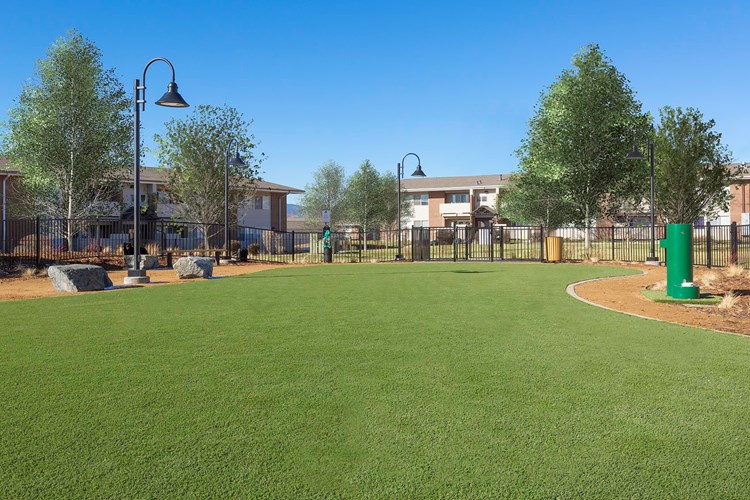 On-site pet park with seating, water station, and bag stations located throughout