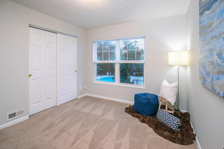 Spacious bedrooms featuring plush carpeting and closets with organizers.