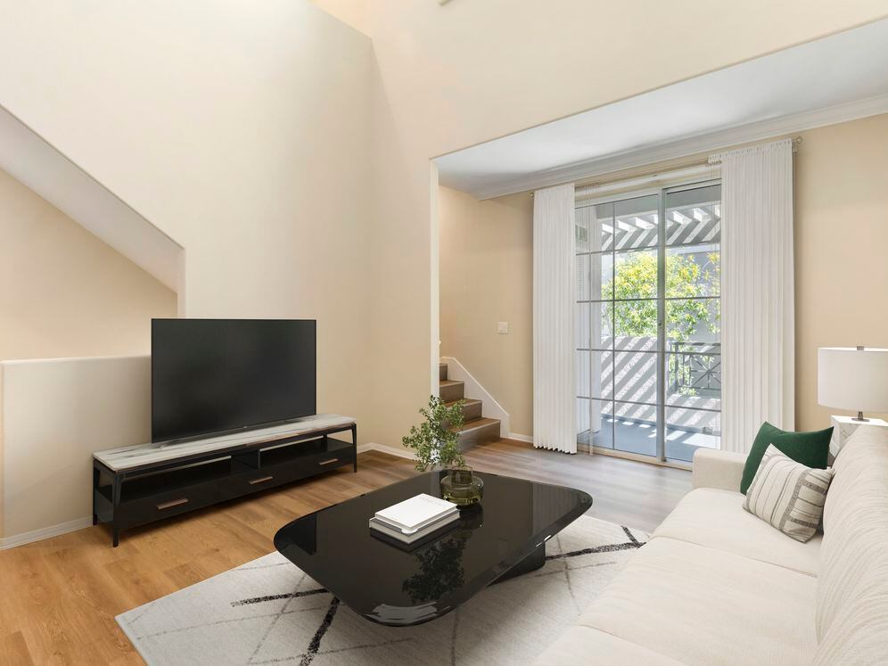 Renovated Package I living room with hard surface flooring