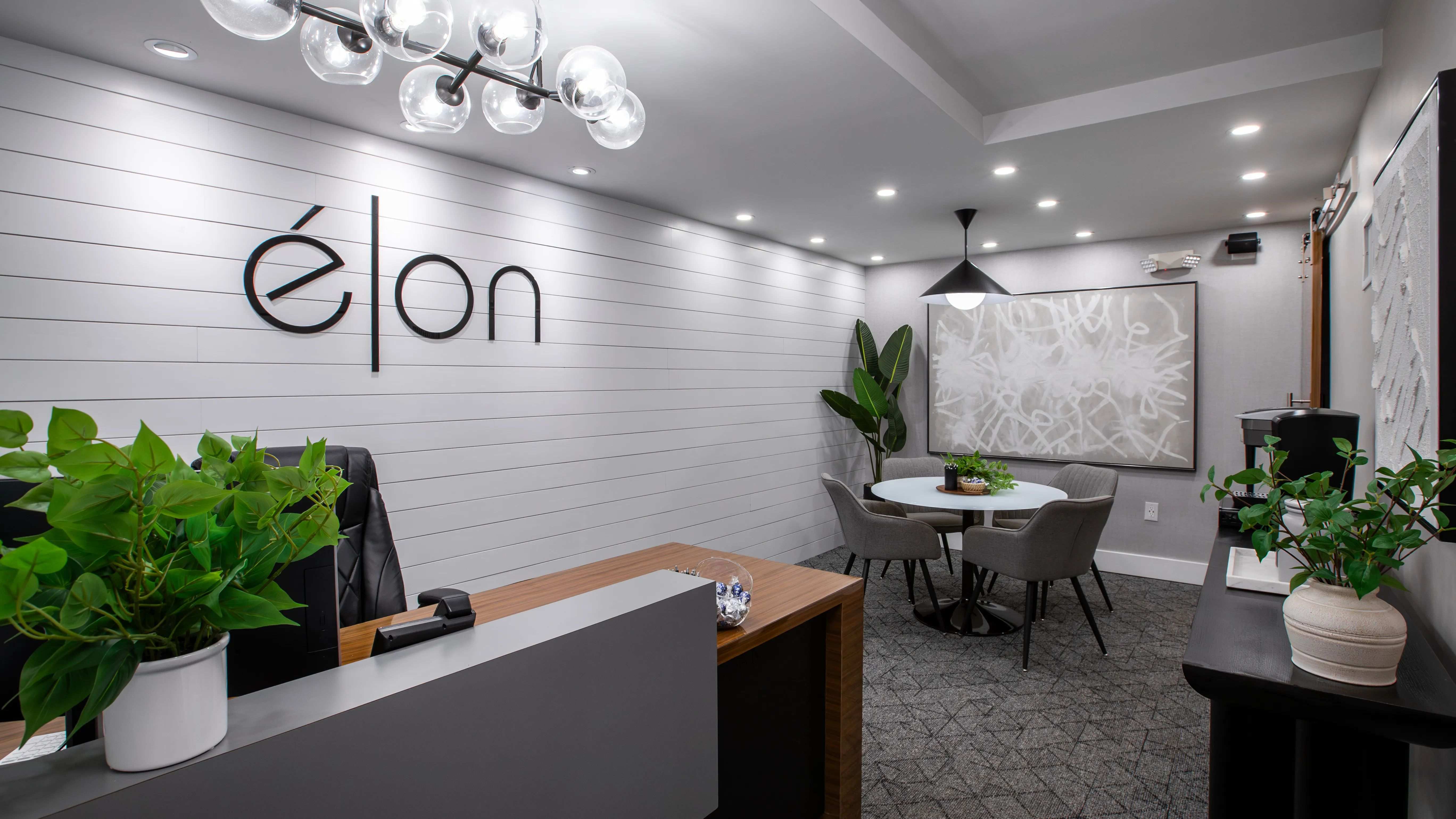 Step into our welcoming leasing office at Elon Winter Park Apartments. With modern décor, sleek design elements, and a comfortable meeting area, this space offers a warm and professional environment for residents and visitors alike.