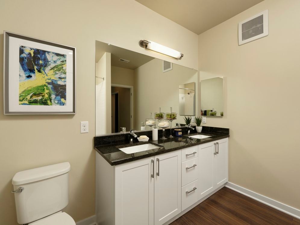 Hunt Valley - Finish Package I Dual vanity bathroom with white shaker cabinetry, granite countertop and hard surface flooring