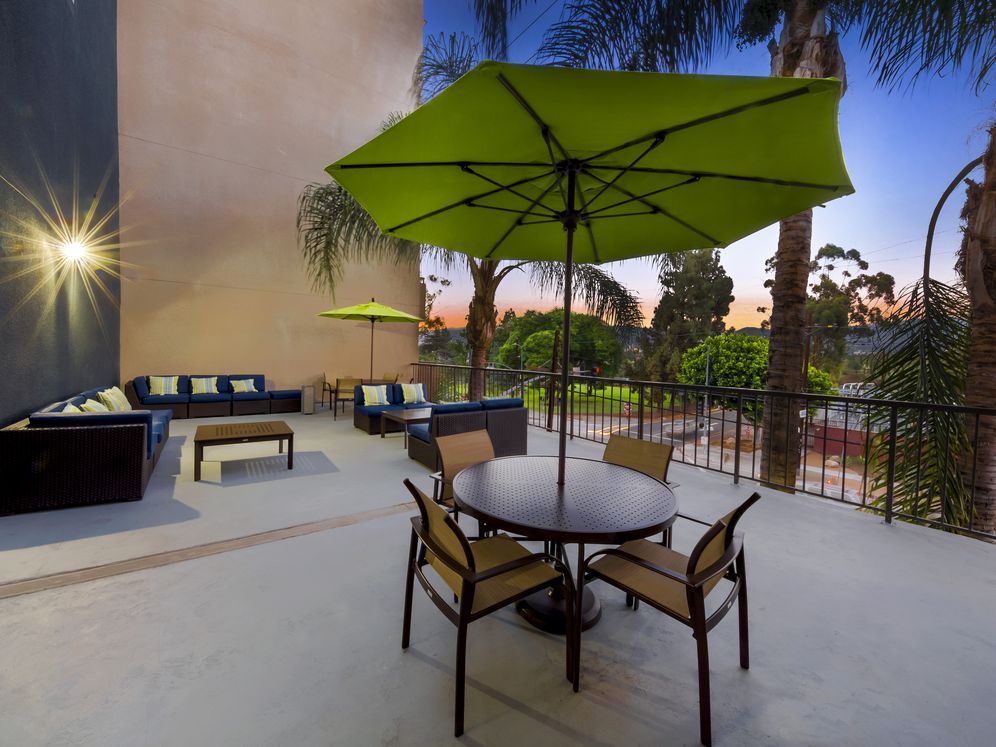 Resident courtyard with barbecue grills, fire pits, and lounge seating