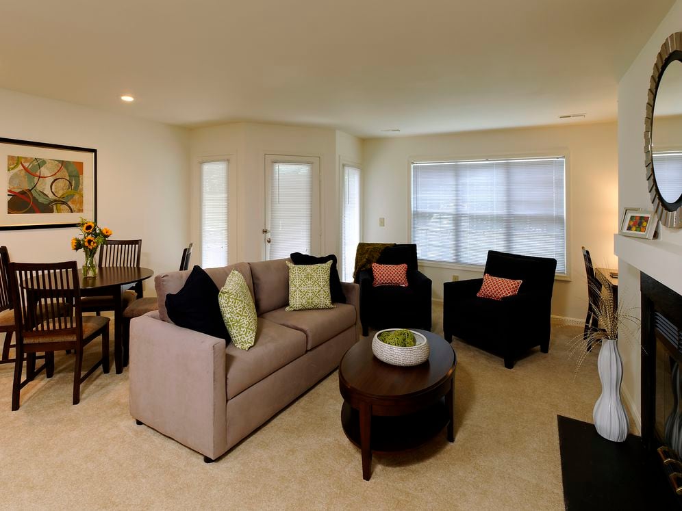 Carpeted dining and living area with fireplace
