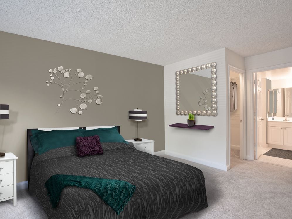 Bedroom with accent wall and carpeted flooring