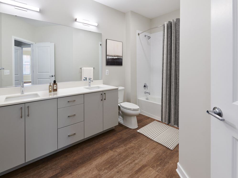 Design Collection I Bath with white quartz stone countertops and hard surface flooring