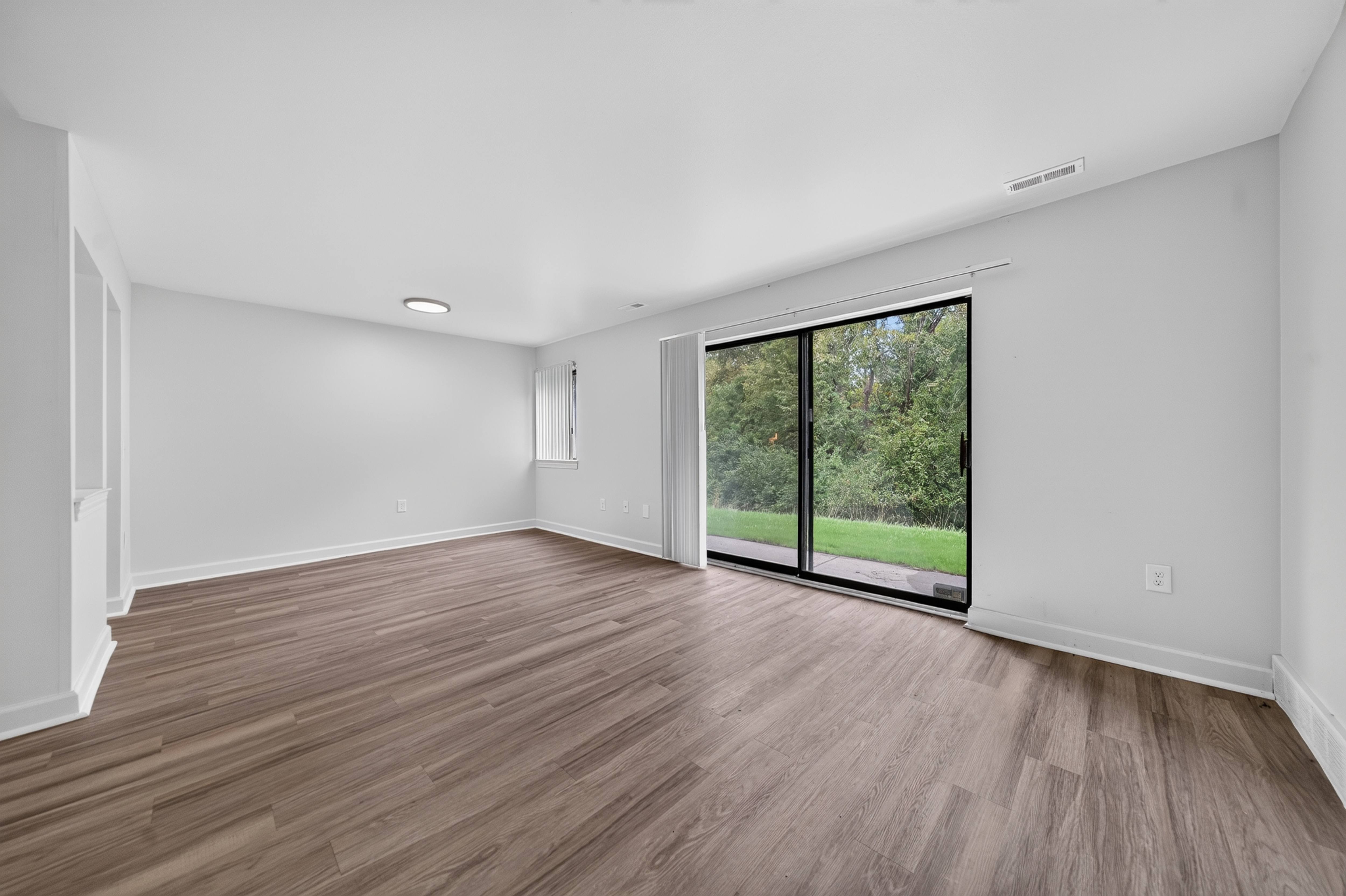 Living room with natural lighting at Franklin River Apartments in Southfield, MI.