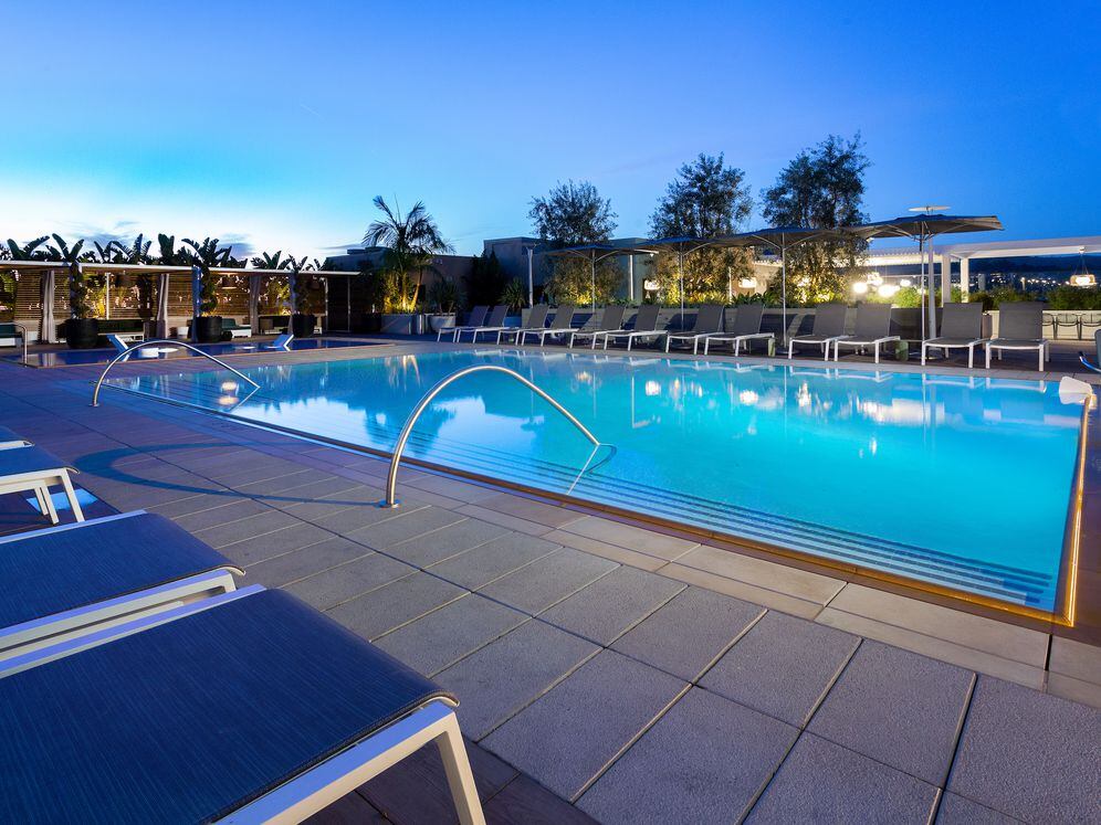 Building A rooftop pool with lounge seating