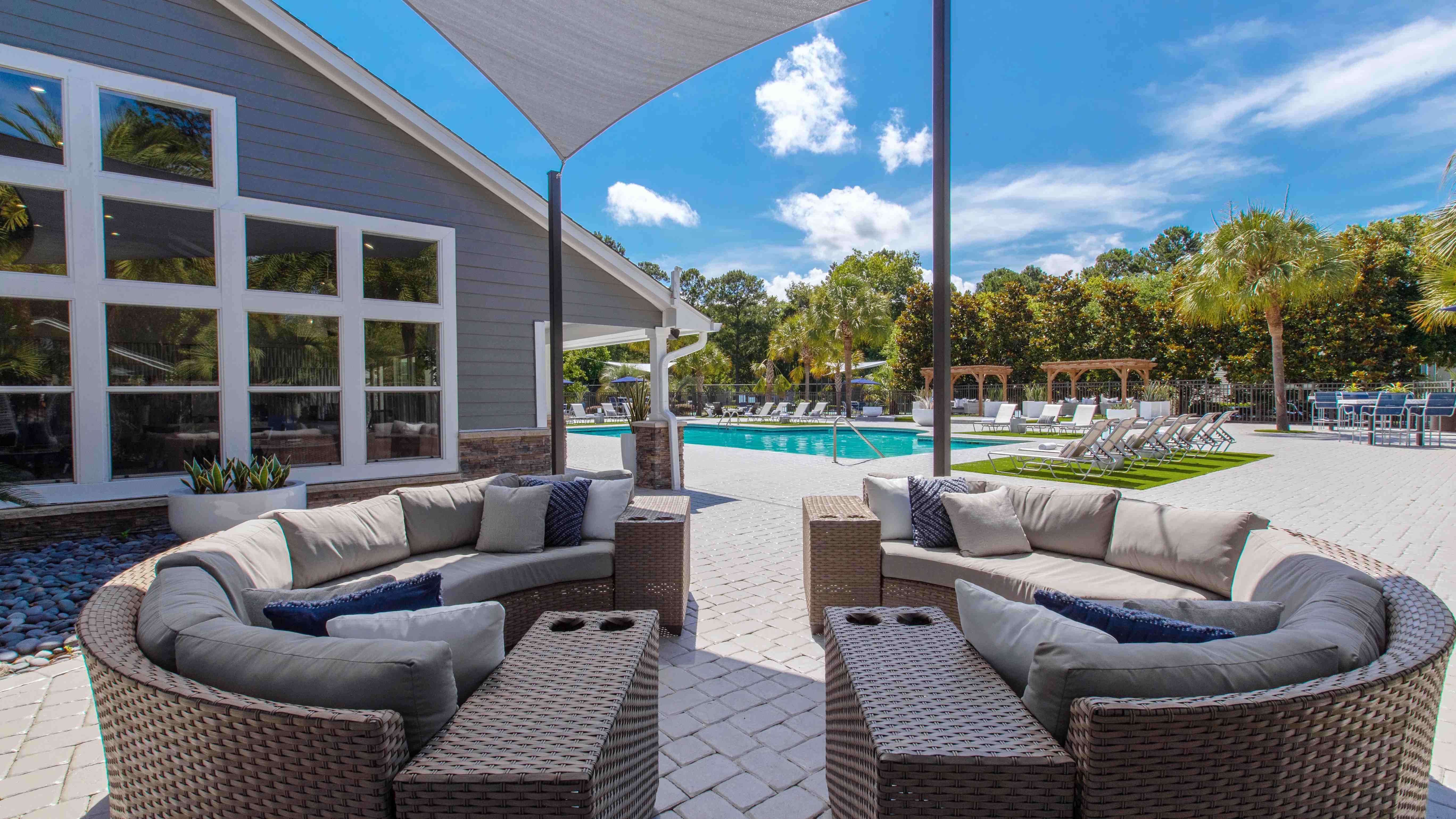 Unwind in style at our poolside outdoor lounge. This shaded retreat features plush seating and offers the perfect ambiance for serene conversations and relaxation.