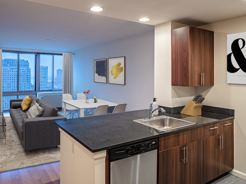 Apartment homes with gourmet kitchens including granite counter tops, stainless steel Whirlpool appliances, gas stovetop, and hard surface flooring
