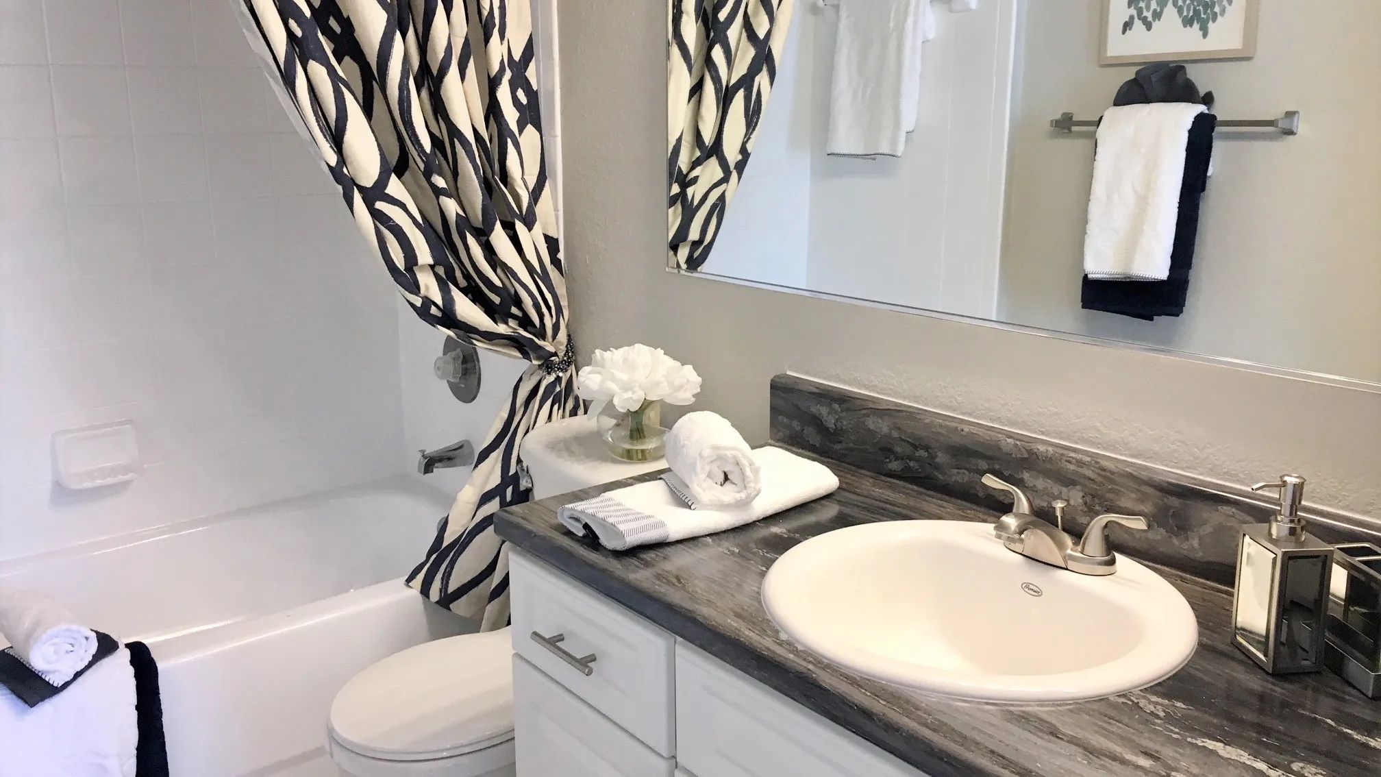 Elevate your bathroom experience with contemporary black fusion countertops – a premium upgrade offered in select homes. Step into a space that's as trendy as it is functional. 