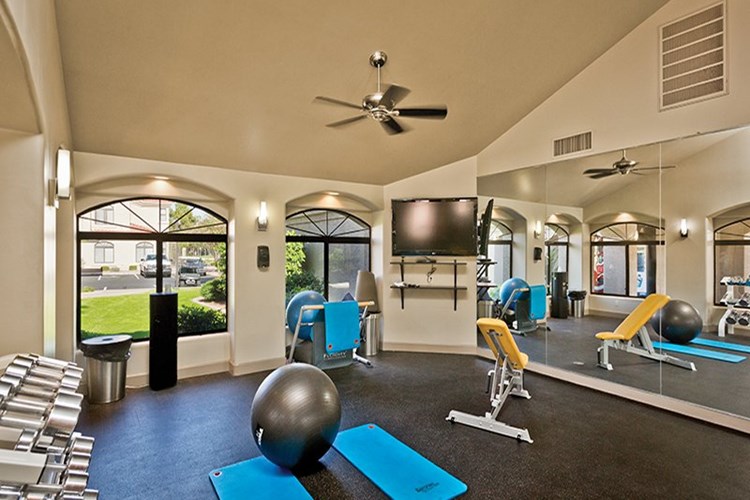 Fitness center features free weights and flat screen TVs