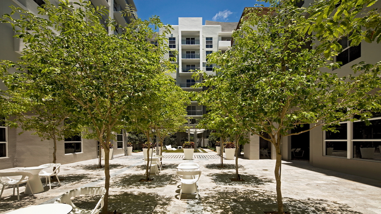 Lushly landscaped grounds and green features.