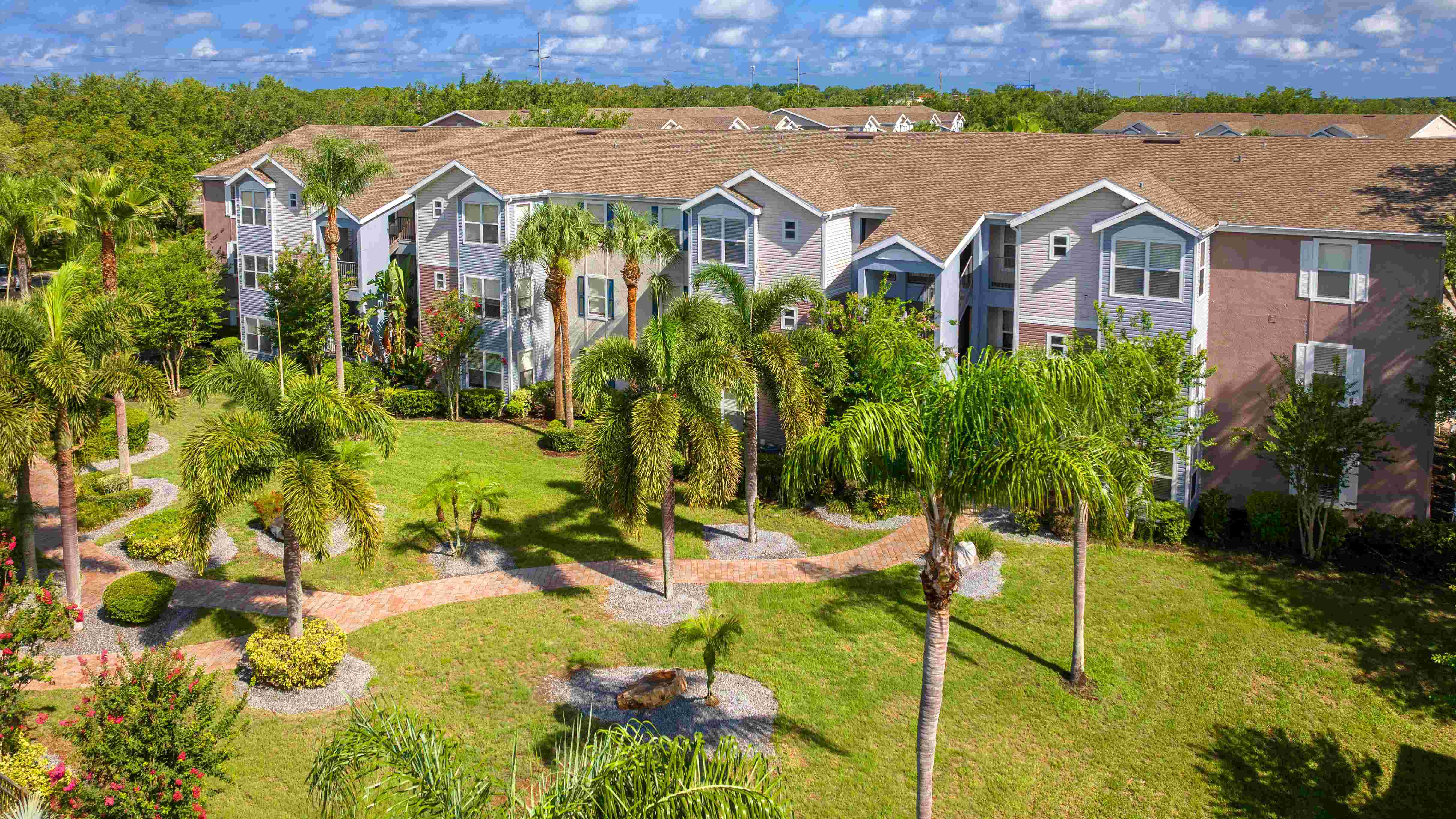 Ashton Chase offers resort-style living with lush greenery, winding brick walkways, and serene views from every apartment.