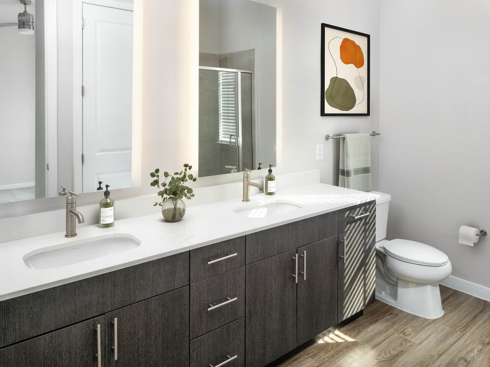 Bath with quartz countertop, tile backsplash, and hard surface flooring