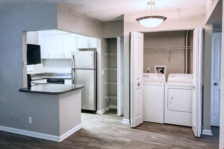 Updated kitchens with black fusion countertops, wood-style flooring and stainless steel appliances are available.