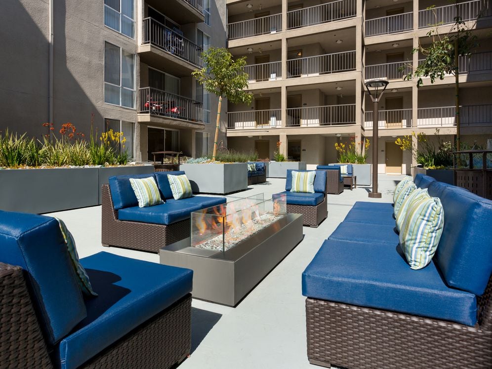 Resident courtyard with barbecue grills, fire pits, and lounge seating