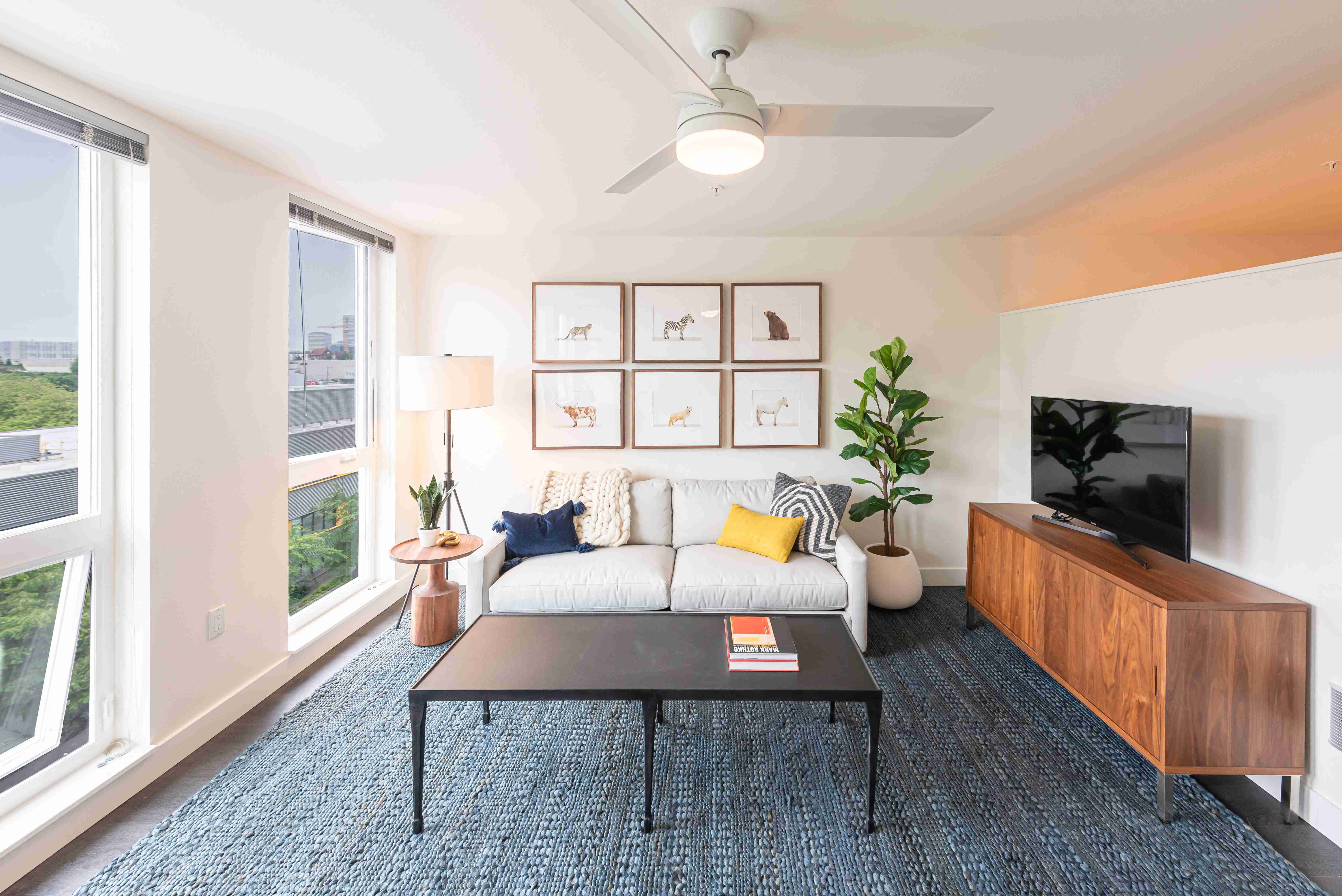Living Room with Floor to Ceiling Windows and a Ceiling Fan