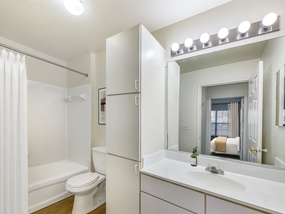 Classic Package II bath with white cultured marble countertops, white cabinetry, and hard surface flooring