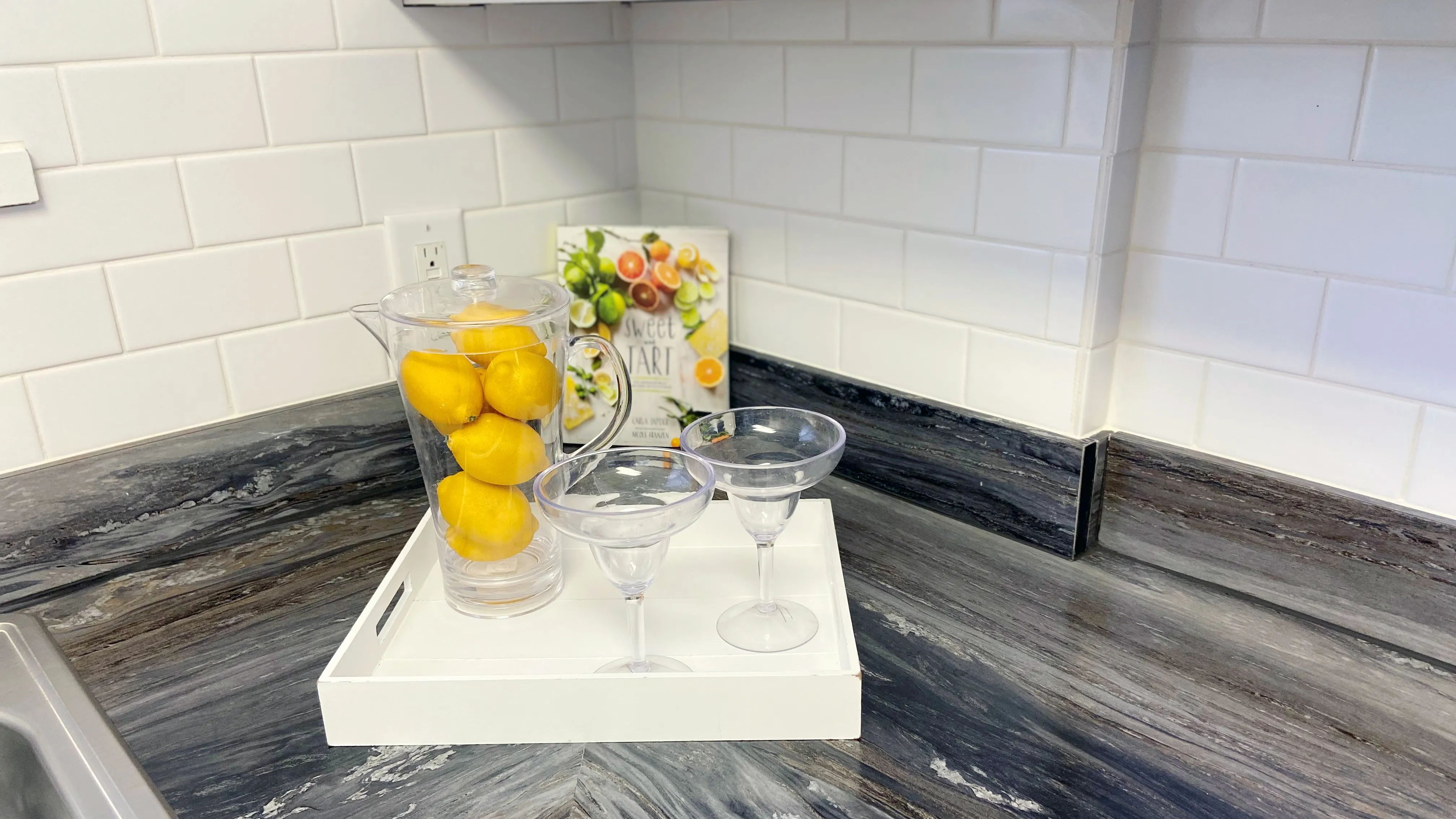 Step into a realm of timeless sophistication in our studio apartments, where gleaming white subway-tiled backsplash weaves classic elegance into contemporary style. 