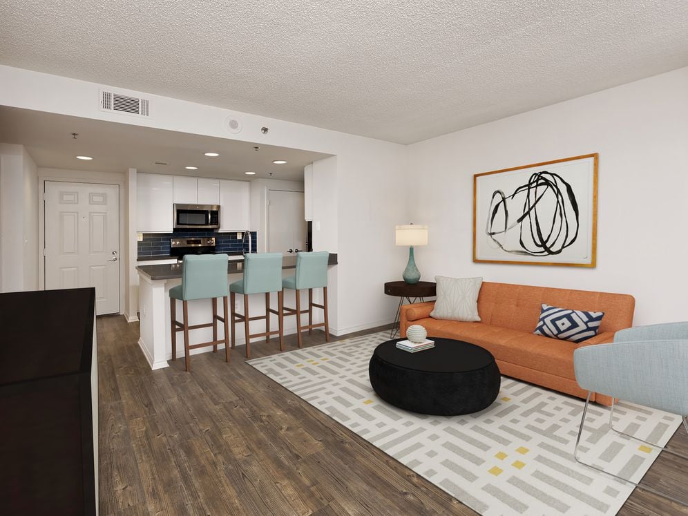 Renovated Package III kitchen with grey quartz countertops, blue tile backsplash, white cabinetry, stainless steel appliances, and hard surface plank flooring